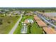 Aerial view showcases the community pool, lawn area, and bocce ball court at 25275 Rampart Blvd # 404, Punta Gorda, FL 33983