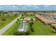 Aerial view showcases the community pool, lawn area, and bocce ball court at 25275 Rampart Blvd # 404, Punta Gorda, FL 33983