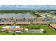 Aerial view showcases the community pool, lawn area, and bocce ball court in a waterfront community at 25275 Rampart Blvd # 404, Punta Gorda, FL 33983