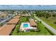 Aerial view showcases the community pool, bocce ball court and lush landscaping at 25275 Rampart Blvd # 404, Punta Gorda, FL 33983