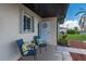 Inviting front porch with seating, a decorative wreath, and charming curb appeal at 25275 Rampart Blvd # 404, Punta Gorda, FL 33983