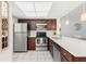 Well-equipped kitchen with stainless steel appliances, white countertops, and ample cabinet space at 25275 Rampart Blvd # 404, Punta Gorda, FL 33983