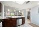 Open-concept kitchen featuring stainless steel appliances, a view into the living room, and ample counter space at 25275 Rampart Blvd # 404, Punta Gorda, FL 33983
