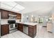 Bright kitchen showcasing stainless steel appliances, a breakfast bar, and a seamless flow to the living area at 25275 Rampart Blvd # 404, Punta Gorda, FL 33983