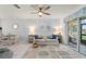 Living room featuring comfortable sofa, tile floors, ceiling fan and sliding glass doors at 25275 Rampart Blvd # 404, Punta Gorda, FL 33983