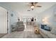 Open-concept living room with living area and kitchen featuring tile floors and ceiling fan at 25275 Rampart Blvd # 404, Punta Gorda, FL 33983