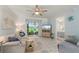 Living room showcasing tile floors, sofa, ceiling fan, and sliding doors to the patio at 25275 Rampart Blvd # 404, Punta Gorda, FL 33983