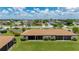 Back of home boasts a spacious lawn area and covered porch perfect for enjoying the outdoors at 25275 Rampart Blvd # 404, Punta Gorda, FL 33983