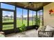 Inviting sunroom with lots of natural light, neutral tile floors, and lovely landscaping at 25275 Rampart Blvd # 404, Punta Gorda, FL 33983
