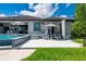 Backyard featuring a luxurious pool, a covered patio, and lush landscaping, ideal for outdoor entertaining at 25462 Shore Dr, Punta Gorda, FL 33950