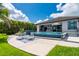 Backyard featuring a luxurious pool, a covered patio, and lush landscaping, ideal for outdoor entertaining at 25462 Shore Dr, Punta Gorda, FL 33950