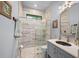 Tastefully appointed bathroom with updated single vanity and glass shower at 25462 Shore Dr, Punta Gorda, FL 33950
