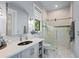 Bright bathroom features single vanity, glass shower, and neutral tile at 25462 Shore Dr, Punta Gorda, FL 33950