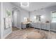 Stunning primary bathroom with chandelier, dual vanity, makeup area, and tiled floors at 25462 Shore Dr, Punta Gorda, FL 33950
