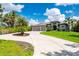 Beautiful home with a circular driveway and lush landscaping at 25462 Shore Dr, Punta Gorda, FL 33950