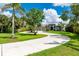 Beautiful home with a circular driveway and lush landscaping at 25462 Shore Dr, Punta Gorda, FL 33950