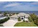 Waterfront home with lush landscaping, an ample driveway and private dock beyond at 25462 Shore Dr, Punta Gorda, FL 33950