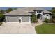 Beautiful home with a three-car garage and an arched entryway and large driveway at 25462 Shore Dr, Punta Gorda, FL 33950