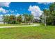 Beautiful home with a circular driveway and lush landscaping at 25462 Shore Dr, Punta Gorda, FL 33950