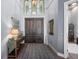 Spacious foyer with soaring ceilings, wood floors, and double doors at 25462 Shore Dr, Punta Gorda, FL 33950