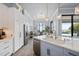 Modern kitchen features a large island, stainless steel appliances, and views of the water at 25462 Shore Dr, Punta Gorda, FL 33950