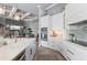Beautiful kitchen with custom cabinets, island, and stainless steel appliances is open to the living room at 25462 Shore Dr, Punta Gorda, FL 33950