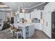 Bright, open kitchen with a large island, bar seating, and modern lighting at 25462 Shore Dr, Punta Gorda, FL 33950