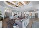 Expansive living room features high ceilings, gray sofas, and an open layout to the kitchen at 25462 Shore Dr, Punta Gorda, FL 33950
