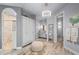 Main bathroom featuring dual vanities, walk in shower, and tile floors at 25462 Shore Dr, Punta Gorda, FL 33950