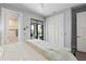 Bedroom with sliding doors to patio, walk-in closet, and access to ensuite bath at 25462 Shore Dr, Punta Gorda, FL 33950