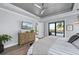 Main bedroom featuring wood floors, television, and views of the pool at 25462 Shore Dr, Punta Gorda, FL 33950