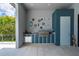 Outdoor grill area featuring a stainless steel grill, storage, and seating with tropical foliage backdrop at 25462 Shore Dr, Punta Gorda, FL 33950