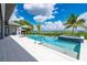 Gorgeous pool and hot tub overlooking the water, complemented by lounge chairs and lush landscaping at 25462 Shore Dr, Punta Gorda, FL 33950