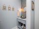 Charming powder room with gray vanity, vessel sink, mosaic tile, and coastal-themed decor at 25462 Shore Dr, Punta Gorda, FL 33950