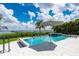 Beautiful pool and patio area offering stunning water views, with an umbrella for shade, perfect for relaxation at 25462 Shore Dr, Punta Gorda, FL 33950