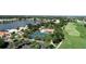Overhead view of community featuring tennis courts, a lake, parking, and green fairways surrounded by homes at 26254 Stillwater Cir, Punta Gorda, FL 33955
