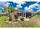 Charming backyard featuring a cozy screened-in patio and lush landscaping with decorative stone accents, creating a peaceful oasis at 26254 Stillwater Cir, Punta Gorda, FL 33955
