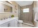 Modern bathroom with glass shower, mosaic floor, and white vanity at 26254 Stillwater Cir, Punta Gorda, FL 33955