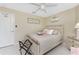 Comfortable bedroom featuring beachy decor, neutral tones, and a luggage rack at 26254 Stillwater Cir, Punta Gorda, FL 33955