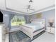 Bedroom featuring a king-sized bed, neutral walls, and a large window with a view at 26254 Stillwater Cir, Punta Gorda, FL 33955