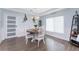 Bright dining room featuring a round table, wainscoting, and modern light fixtures at 26254 Stillwater Cir, Punta Gorda, FL 33955