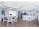 Open-concept dining area with adjacent kitchen, bar seating, and modern appliances at 26254 Stillwater Cir, Punta Gorda, FL 33955
