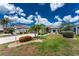 Charming home with a well-manicured front yard, attractive landscaping, and a welcoming entrance, showcasing curb appeal at 26254 Stillwater Cir, Punta Gorda, FL 33955