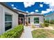 Inviting front exterior features a well-maintained lawn, attractive landscaping, and a charming walkway leading to the entrance at 26254 Stillwater Cir, Punta Gorda, FL 33955