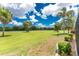 Scenic view of the golf course from the property, featuring lush greenery, mature trees, and manicured landscaping at 26254 Stillwater Cir, Punta Gorda, FL 33955