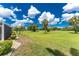 Tranquil view of the golf course from the property, featuring manicured greens and mature trees, offering a serene setting at 26254 Stillwater Cir, Punta Gorda, FL 33955