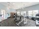 A spacious gym features a variety of exercise equipment, bright lighting, and a library corner for a well-rounded fitness experience at 26254 Stillwater Cir, Punta Gorda, FL 33955