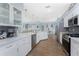 Bright kitchen featuring white cabinets, stainless steel appliances, and an open floor plan at 26254 Stillwater Cir, Punta Gorda, FL 33955