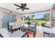 Screened lanai showcasing cozy seating and expansive golf course views at 26254 Stillwater Cir, Punta Gorda, FL 33955