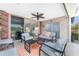 Charming lanai with stylish seating, ceiling fan, and view to the golf course at 26254 Stillwater Cir, Punta Gorda, FL 33955
